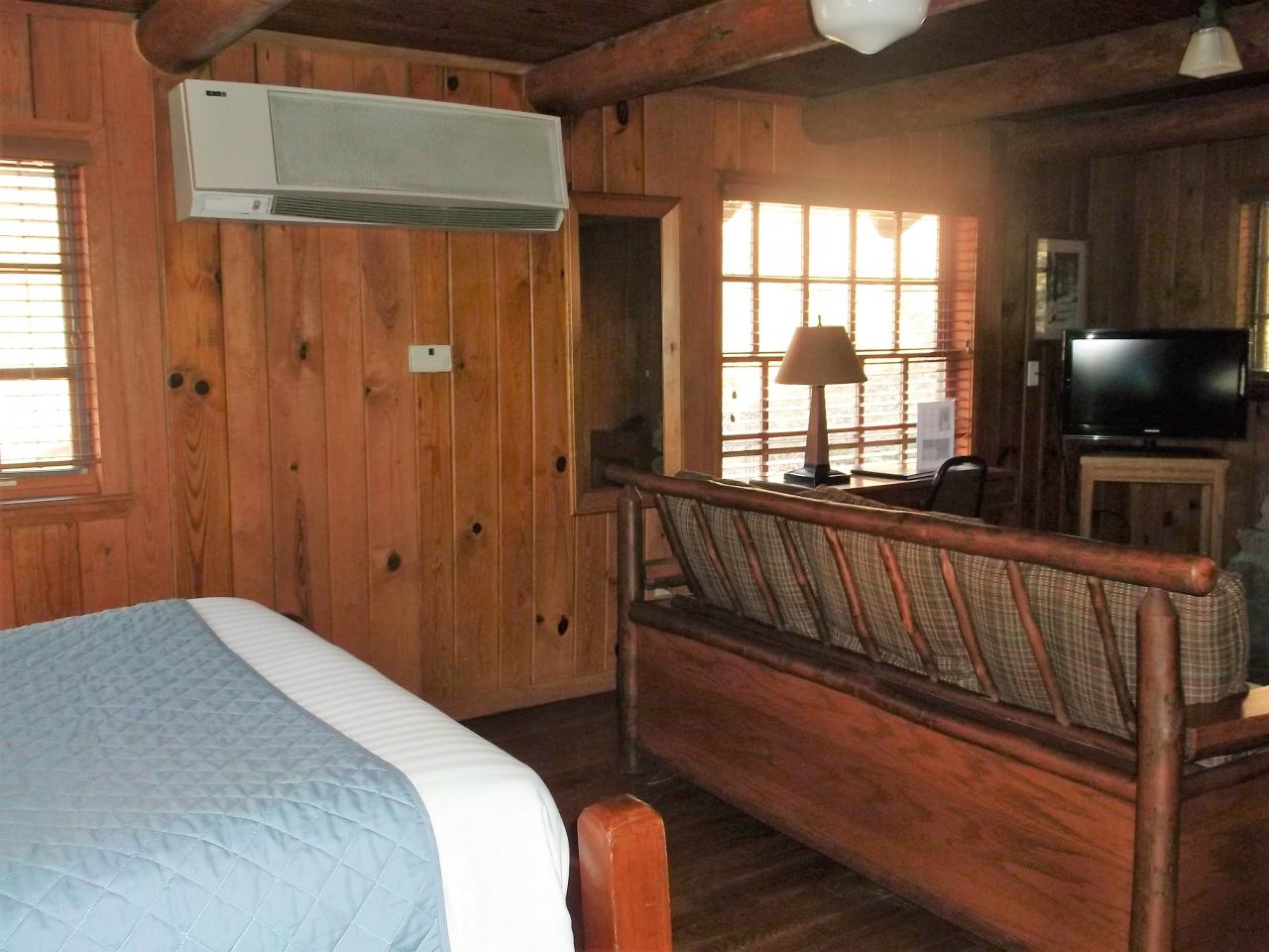 A view of the living room area in the studio cabin 17 including a couch, desk and tv